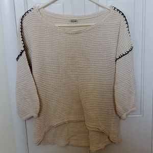 Cream sweater with black stitching